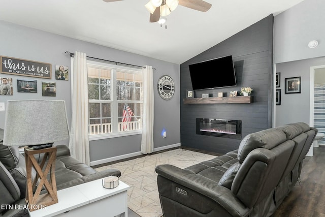 living room featuring vaulted ceiling, ceiling fan, and a fireplace