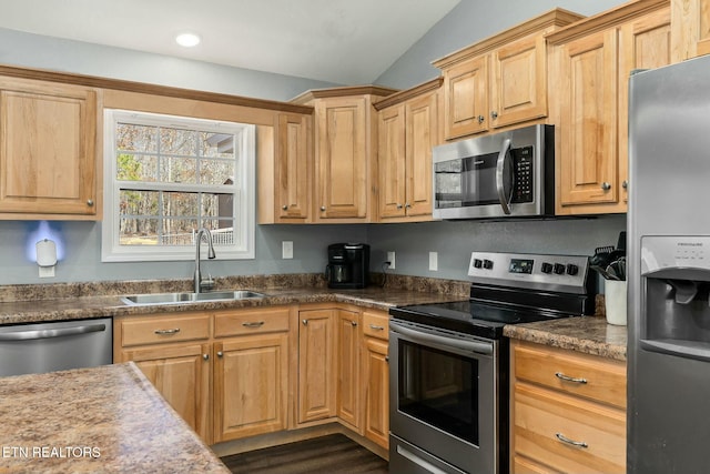 kitchen featuring stainless steel appliances, light brown cabinetry, and sink