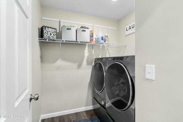 washroom featuring washing machine and clothes dryer and hardwood / wood-style floors