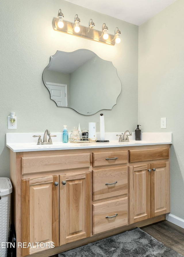 bathroom with hardwood / wood-style flooring and vanity