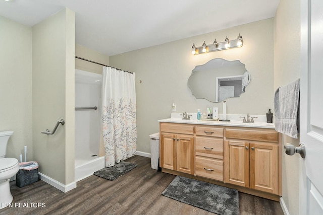 bathroom featuring vanity, hardwood / wood-style floors, curtained shower, and toilet