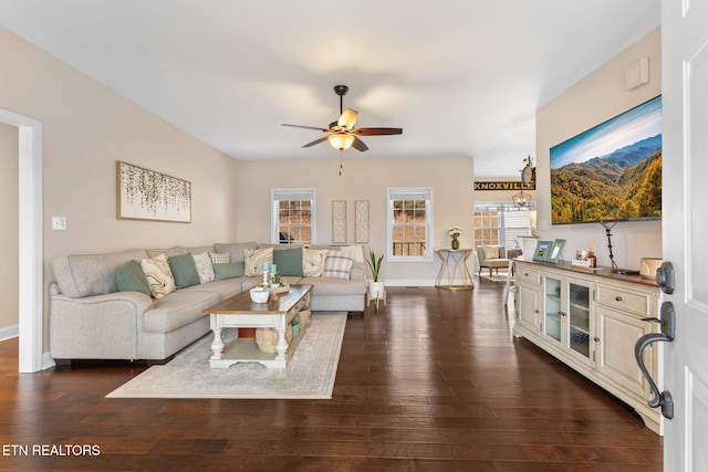 living room with ceiling fan and dark hardwood / wood-style flooring