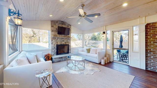 living room featuring vaulted ceiling, a fireplace, dark hardwood / wood-style flooring, ceiling fan, and wood ceiling