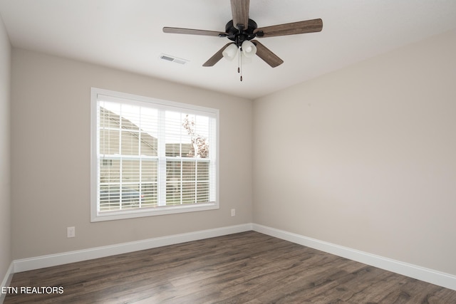 empty room featuring ceiling fan and dark hardwood / wood-style flooring