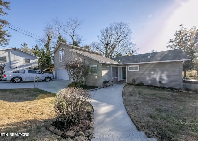 view of front of property with a garage and a front yard