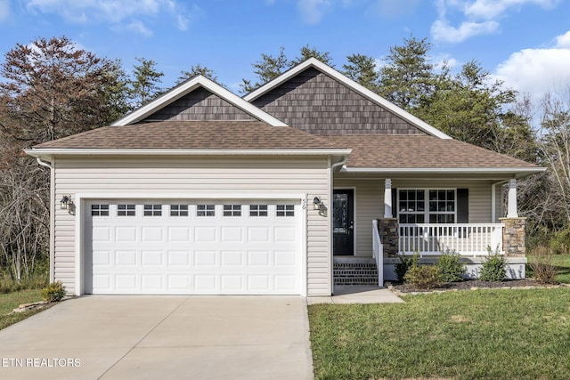 craftsman house with a garage, a front yard, and covered porch