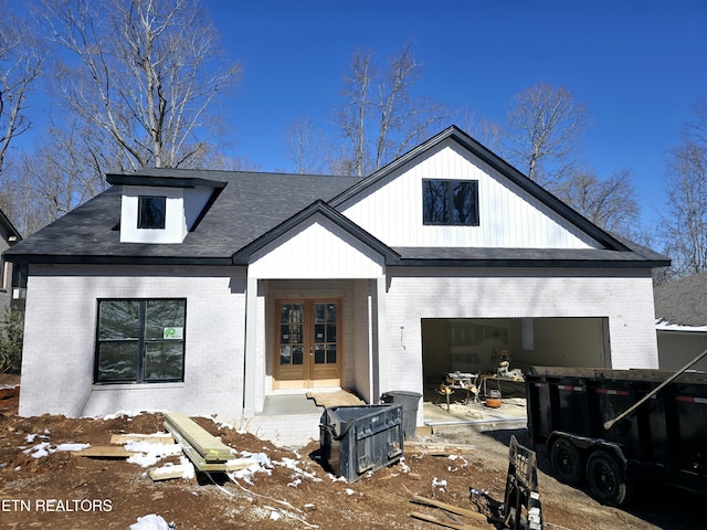 modern farmhouse with french doors and brick siding