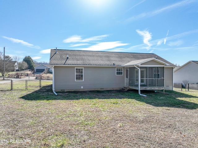 back of property with a yard and a sunroom