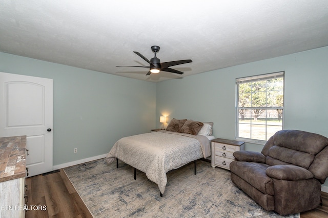 bedroom featuring hardwood / wood-style floors, a textured ceiling, and ceiling fan