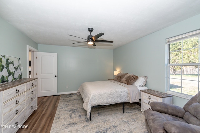 bedroom featuring ceiling fan and dark hardwood / wood-style flooring