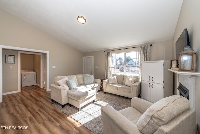 living room with lofted ceiling, washer / dryer, and hardwood / wood-style floors