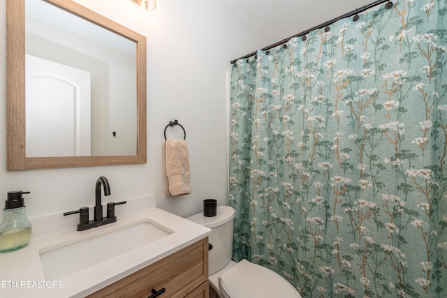 bathroom featuring vanity, toilet, and a shower with shower curtain