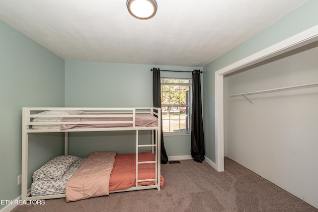 carpeted bedroom featuring a closet