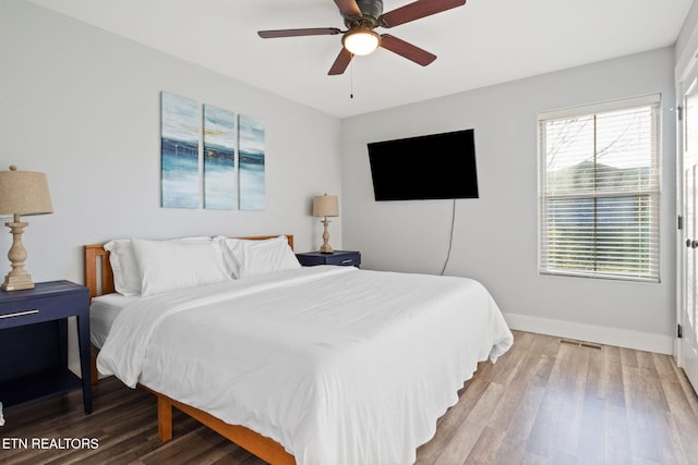 bedroom with wood-type flooring and ceiling fan