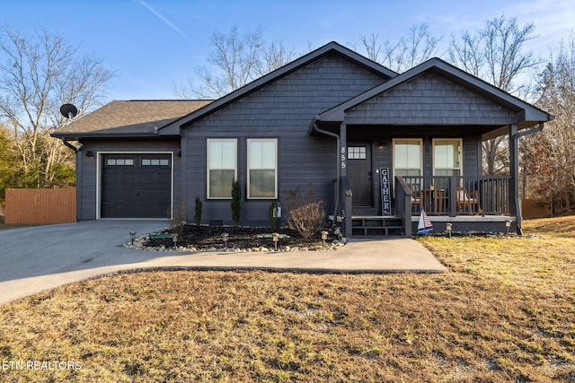 view of front of home featuring a garage, covered porch, and a front lawn