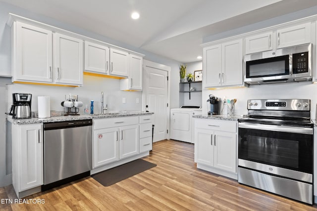 kitchen with white cabinetry, appliances with stainless steel finishes, and sink