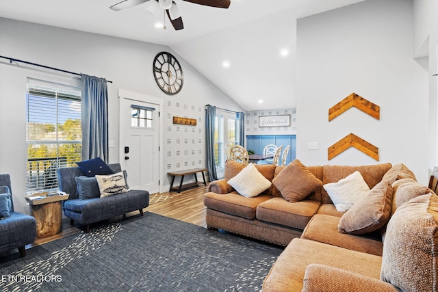 living room with hardwood / wood-style flooring, vaulted ceiling, and ceiling fan