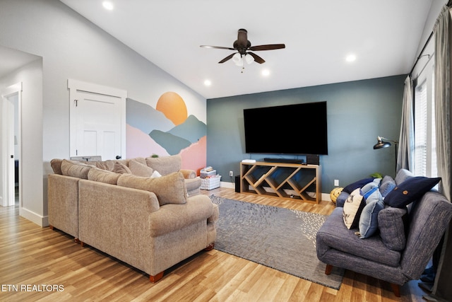 living room with hardwood / wood-style flooring, vaulted ceiling, and ceiling fan