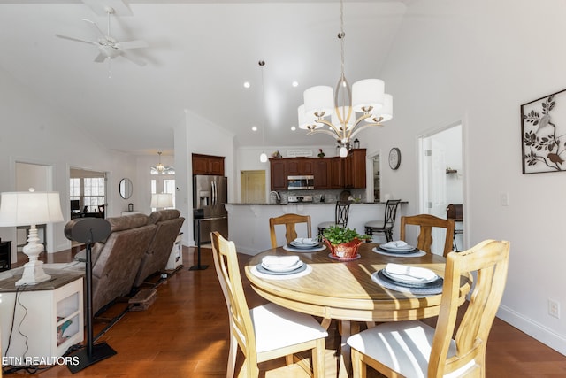 dining area with high vaulted ceiling, ceiling fan with notable chandelier, and dark hardwood / wood-style flooring