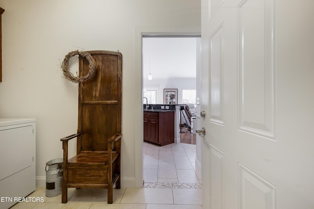 hallway with light tile patterned flooring and washer / clothes dryer