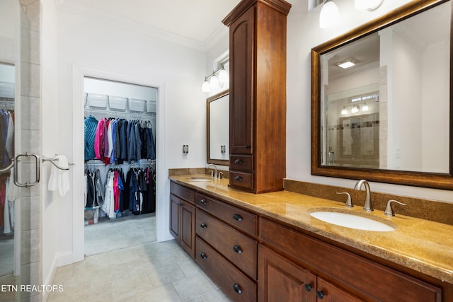 bathroom featuring an enclosed shower, ornamental molding, vanity, and tile patterned floors