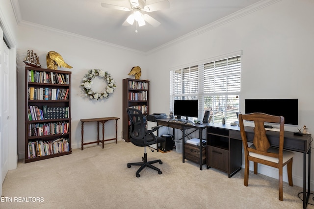 carpeted home office featuring crown molding and ceiling fan