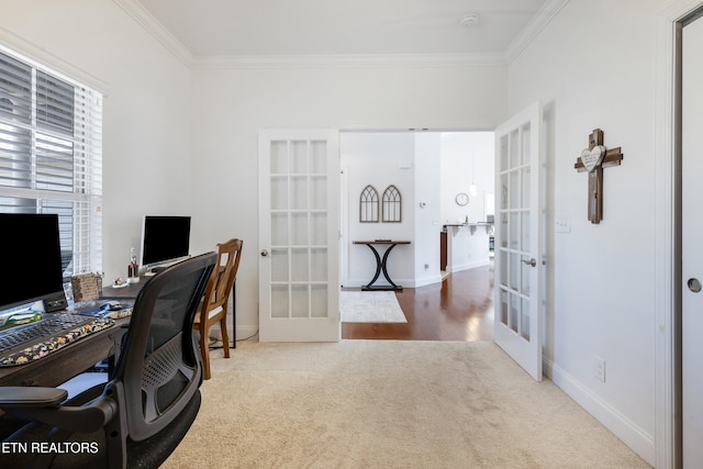 home office with french doors, ornamental molding, and carpet flooring