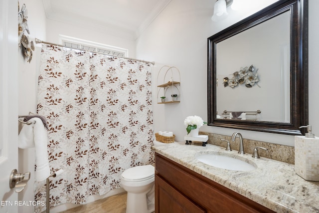 bathroom featuring vanity, crown molding, and toilet