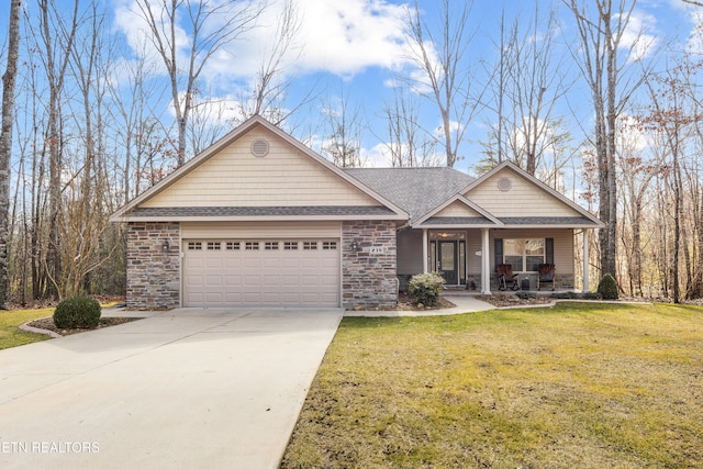 view of front of home with a garage, covered porch, and a front yard