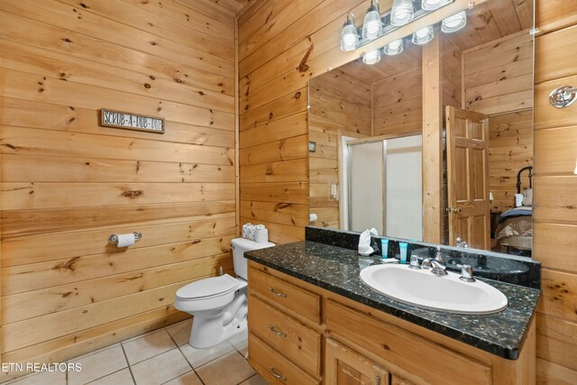 950 Black Bear Cub Way, Sevierville, TN 37862 - bathroom featuring wooden walls, vanity, walk in shower, toilet, and tile patterned floors