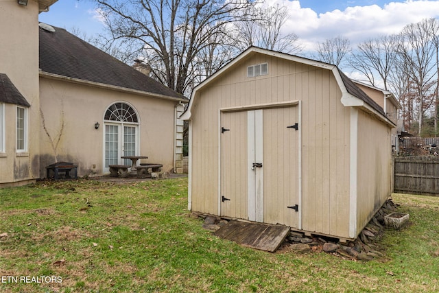 view of outdoor structure featuring a lawn