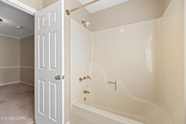 bathroom with shower / tub combination and a textured ceiling