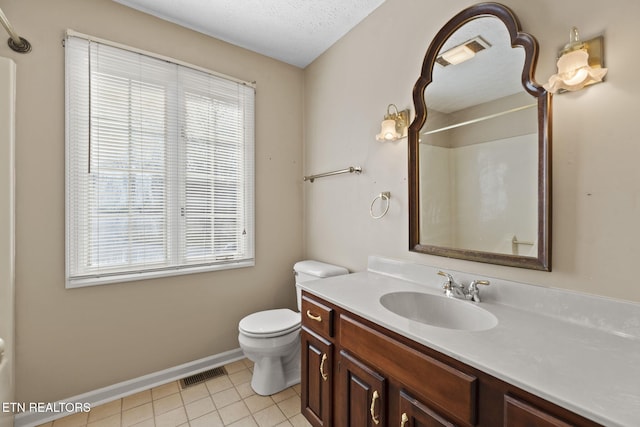 bathroom with vanity, a textured ceiling, tile patterned floors, toilet, and walk in shower