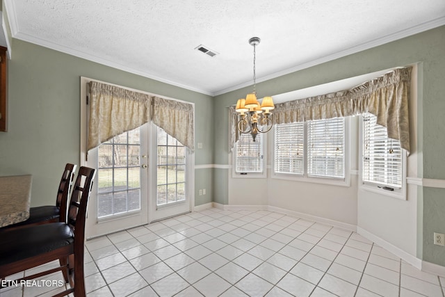 dining room with light tile patterned flooring, a healthy amount of sunlight, and ornamental molding