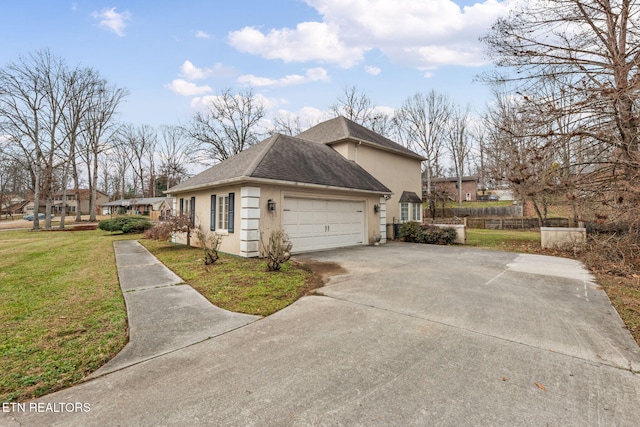 view of home's exterior with a garage and a yard