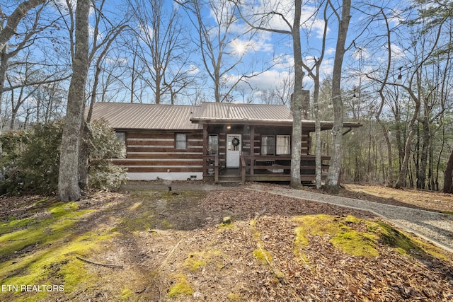 log-style house featuring covered porch