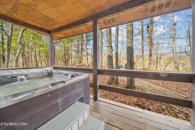 sunroom / solarium with wood ceiling, a healthy amount of sunlight, and a jacuzzi