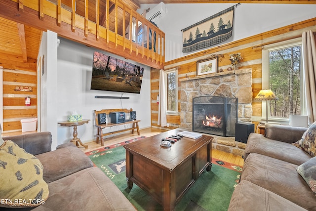 living room featuring dark wood-type flooring, beam ceiling, high vaulted ceiling, a wall unit AC, and a fireplace