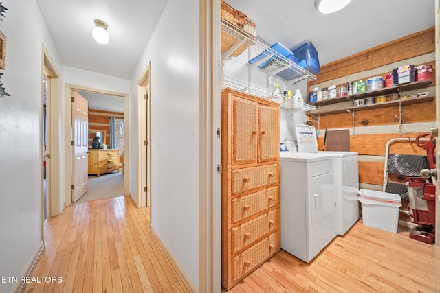 laundry area with light hardwood / wood-style flooring and independent washer and dryer