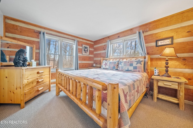 carpeted bedroom with wood walls