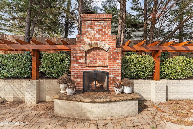 view of patio featuring an outdoor brick fireplace