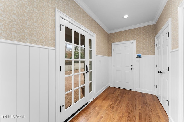 entryway featuring ornamental molding and hardwood / wood-style floors