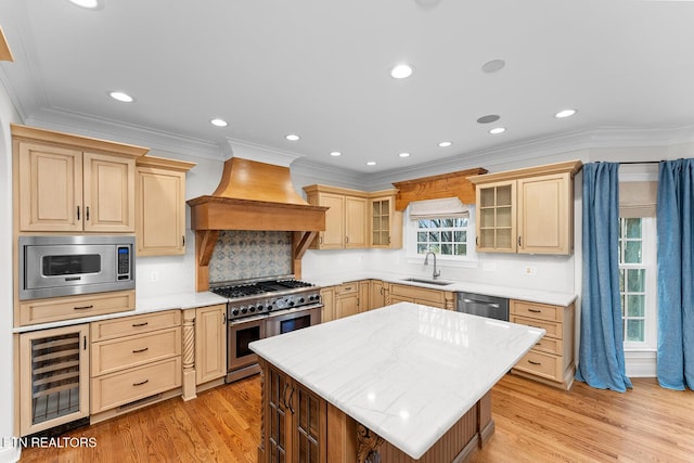 kitchen with wine cooler, premium range hood, sink, a center island, and appliances with stainless steel finishes