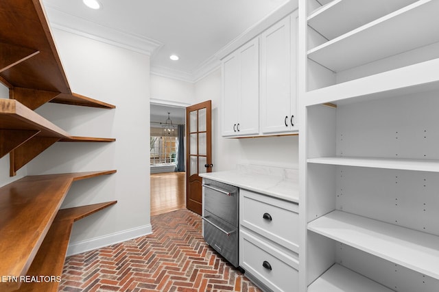 spacious closet featuring a chandelier