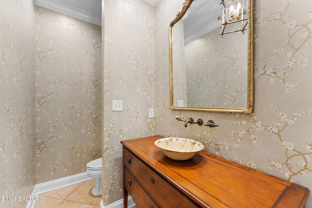 bathroom featuring tile patterned flooring, vanity, ornamental molding, and toilet