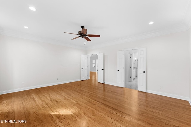 interior space featuring hardwood / wood-style flooring, ornamental molding, and ensuite bathroom