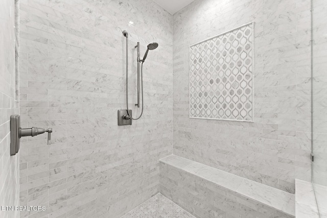 bathroom with tiled shower