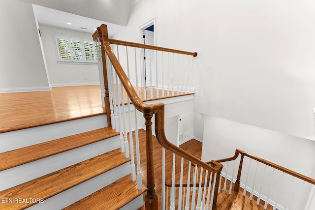 stairs with hardwood / wood-style flooring