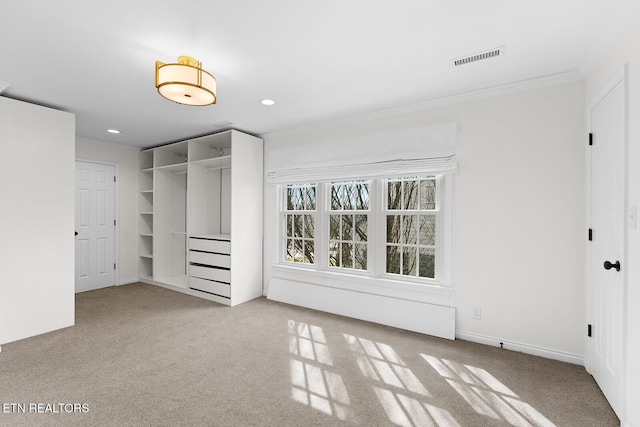 unfurnished bedroom featuring light colored carpet, ornamental molding, and a closet