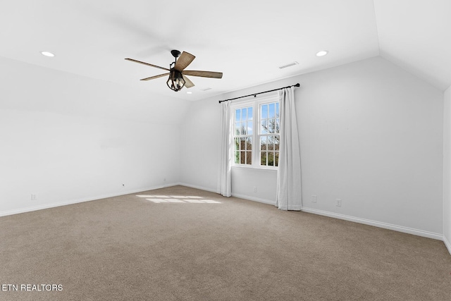 additional living space with vaulted ceiling, light colored carpet, and ceiling fan